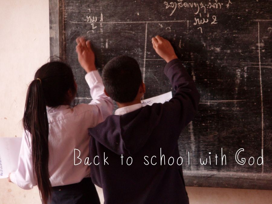 Image of children writing on blackboard with "Back to school with God" in the foreground