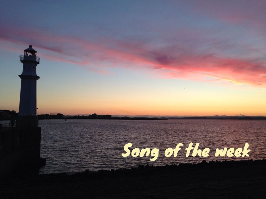 Photo of Newhaven lighthouse at sunset with pink clouds in the sky, and caption "Song of the week"